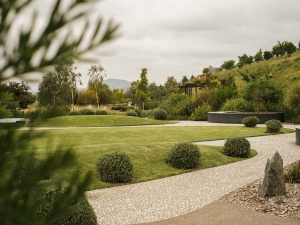 Outdoor garden retreat with trimmed shrubs and stone pathway